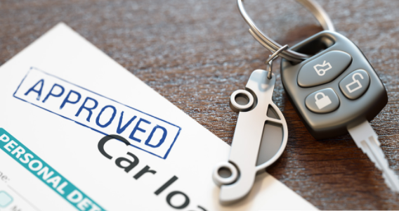 Car loan approval papers resting besides car keys