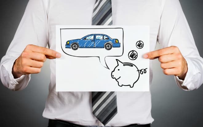 Man holding a paper with a piggy bank and car drawing