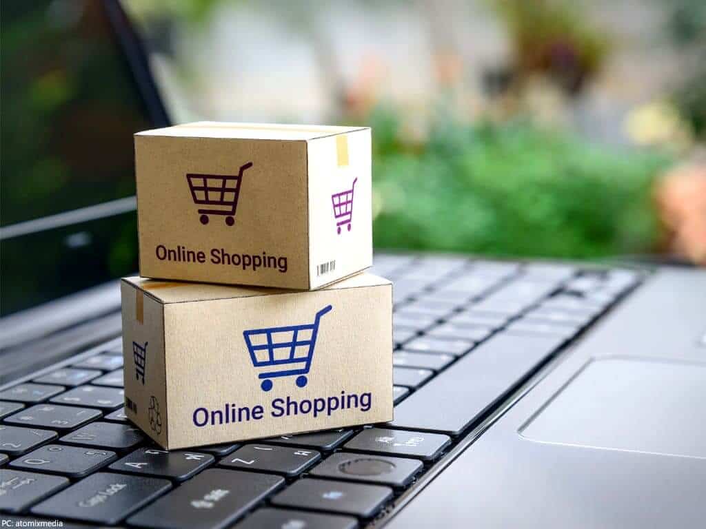 Two online shopping boxed atop each other on laptop keyboard – MyPoints 