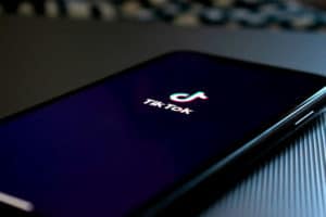 Smartphone lays on a table with the tikTok app enabled.