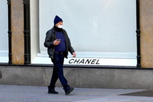 Man walking by closed Chanel boutique