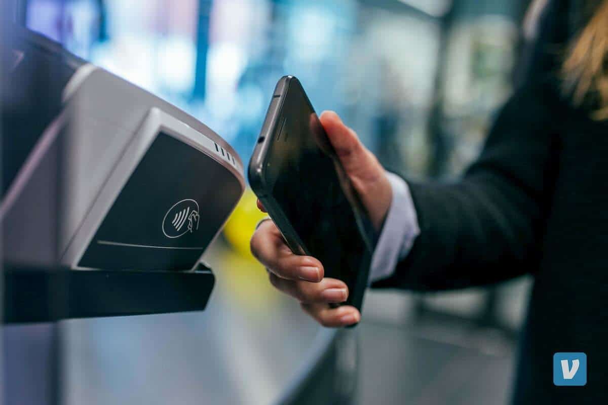 in this photo person pays with smartphone
