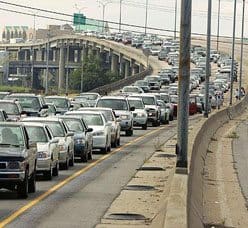 Cars carrying residents leave downtown New Orleans as Hurricane Katrina nears.